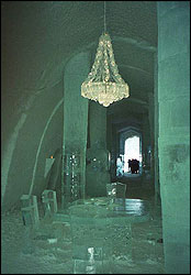 An ice chandelier hanging above an ice table at the Icehotel.