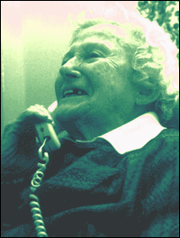 Photograph of an elderly woman speaking on the telephone.