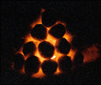 Glowing embers inside the pyramid of snowballs