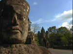 Head of a God on the causeway leading to the South Gate of Angkor Thom.