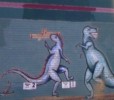 The dinosaurs painted on the outside of the building
